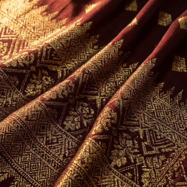 [object Object] — Gold thread through deep colour, lit to catch it.